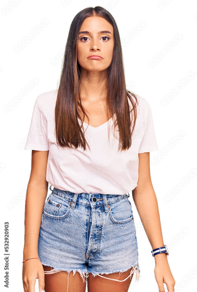Young hispanic woman wearing casual white tshirt depressed and worry for distress, crying angry and afraid. sad expression. Young hispanic woman wearing casual white tshirt depressed and worry for distress, crying angry and afraid. sad expression.
