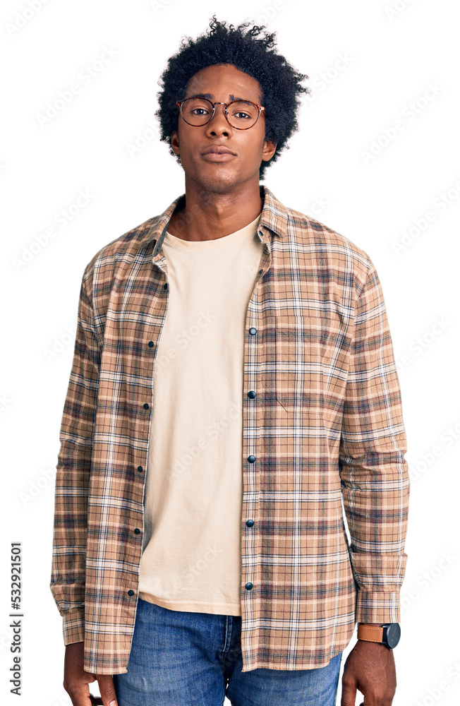 Handsome african american man with afro hair wearing casual clothes and glasses relaxed with serious expression on face. simple and natural looking at the camera. Handsome african american man with afro hair wearing casual clothes and glasses relaxed with serious expression on face. simple and natural looking at the camera.