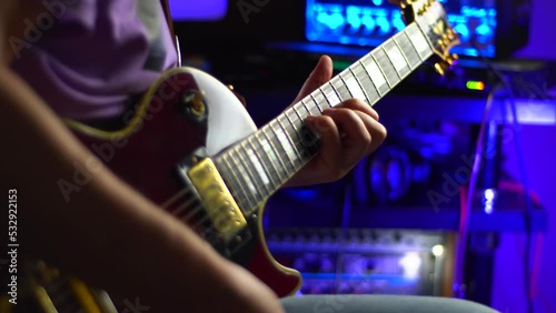 lead guitarist playing electrical guitar at studio	