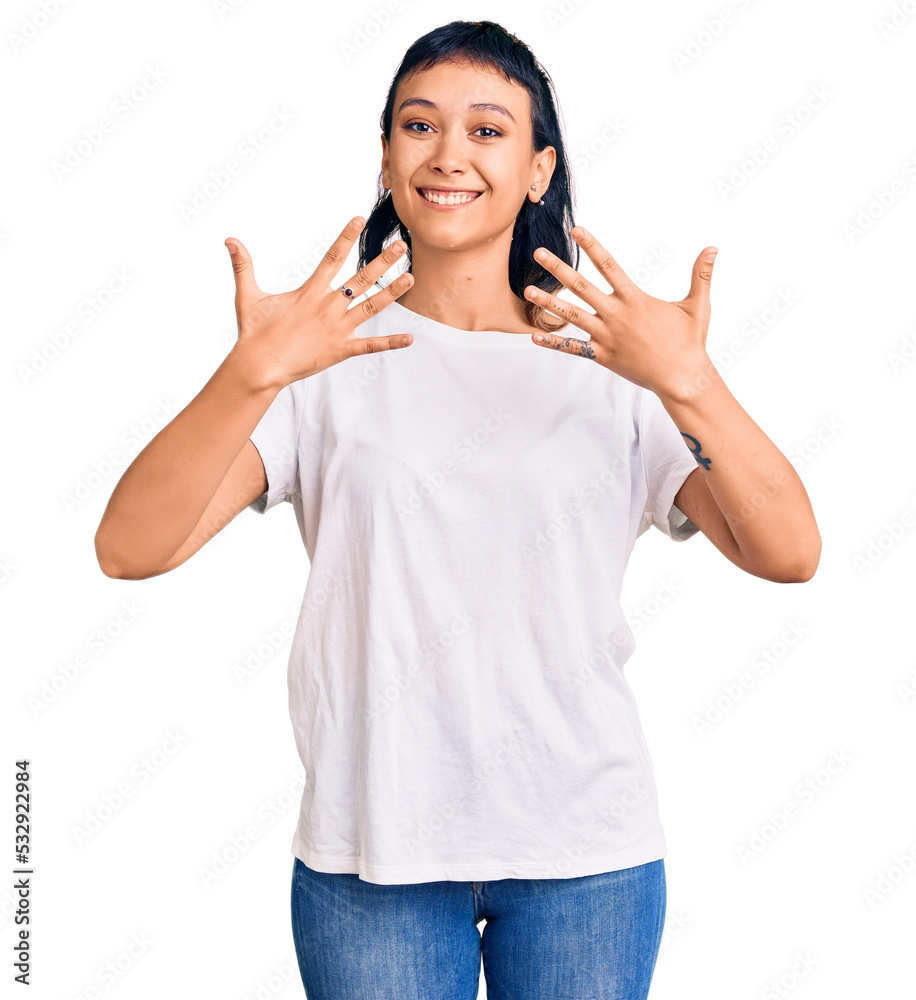 Young woman wearing casual clothes showing and pointing up with fingers number ten while smiling confident and happy. Young woman wearing casual clothes showing and pointing up with fingers number ten while smiling confident and happy.