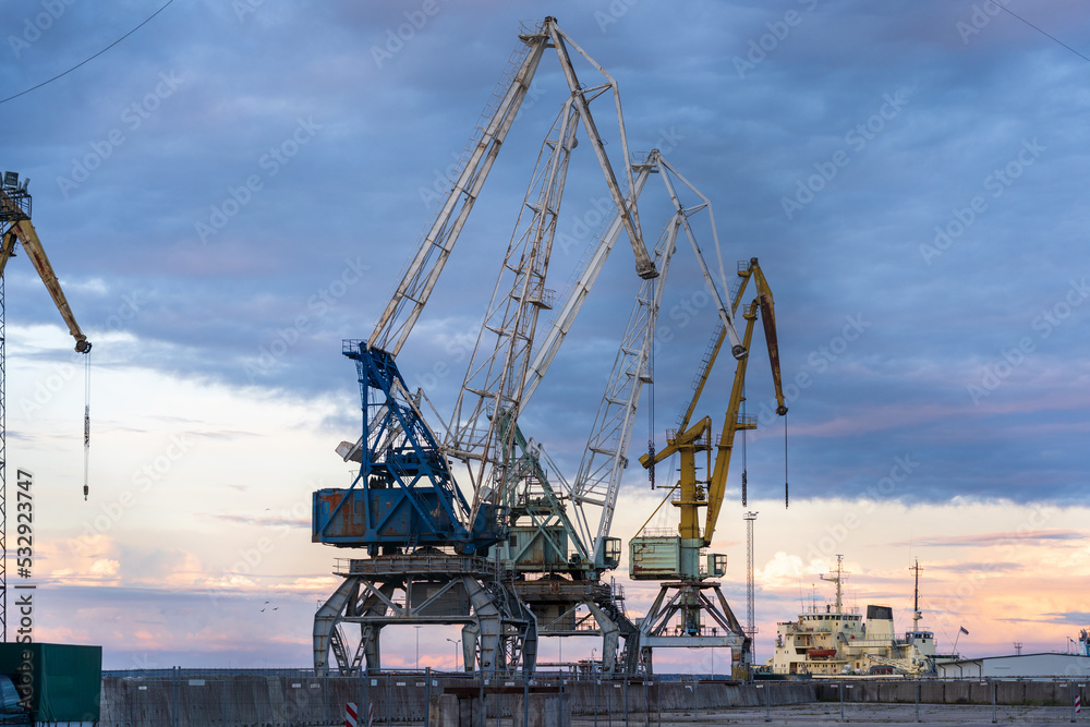 Port in Tallinn for cargo ships with big cranes, photo with beautiful sky.