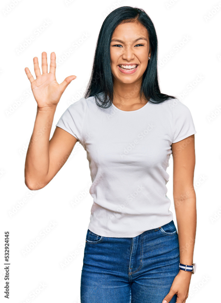Beautiful hispanic woman wearing casual white tshirt showing and pointing up with fingers number five while smiling confident and happy. Beautiful hispanic woman wearing casual white tshirt showing and pointing up with fingers number five while smiling confident and happy.