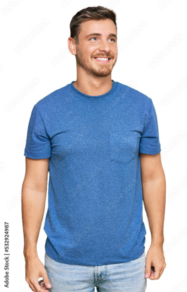 Handsome caucasian man wearing casual clothes looking away to side with smile on face, natural expression. laughing confident. Handsome caucasian man wearing casual clothes looking away to side with smile on face, natural expression. laughing confident.