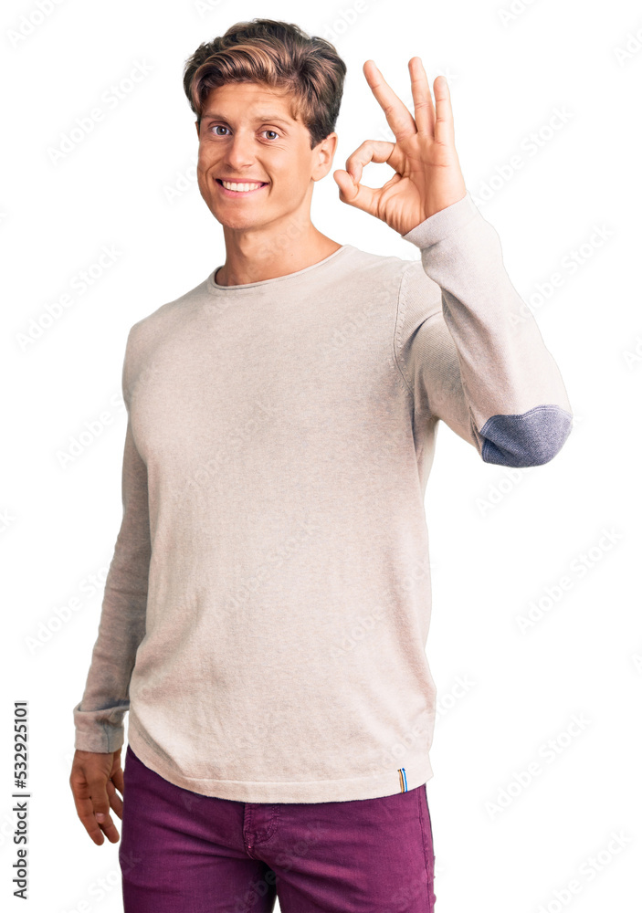 Young handsome man wearing casual clothes smiling positive doing ok sign with hand and fingers. successful expression. Young handsome man wearing casual clothes smiling positive doing ok sign with hand and fingers. successful expression.