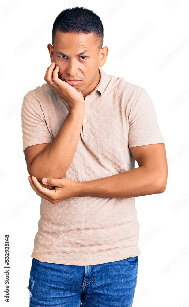 Young handsome latin man wearing casual clothes thinking looking tired and bored with depression problems with crossed arms. Young handsome latin man wearing casual clothes thinking looking tired and bored with depression problems with crossed arms.