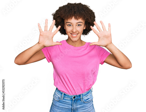 Young hispanic girl wearing casual clothes showing and pointing up with fingers number ten while smiling confident and happy.