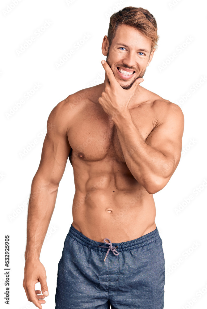 Young caucasian man standing shirtless looking confident at the camera smiling with crossed arms and hand raised on chin. thinking positive. Young caucasian man standing shirtless looking confident at the camera smiling with crossed arms and hand raised on chin. thinking positive.
