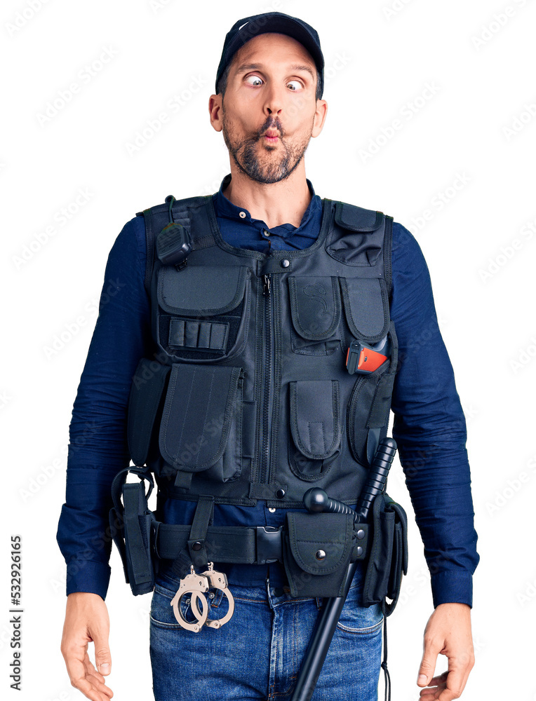 Young handsome man wearing police uniform making fish face with lips, crazy and comical gesture. funny expression. Young handsome man wearing police uniform making fish face with lips, crazy and comical gesture. funny expression.