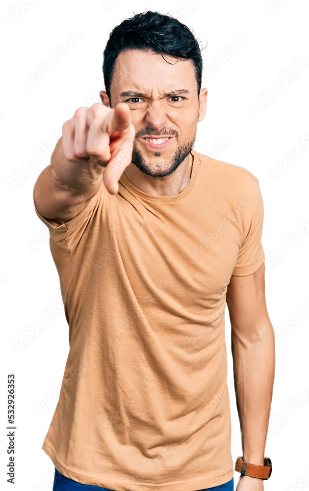 Hispanic man with beard wearing casual t shirt pointing displeased and frustrated to the camera, angry and furious with you Hispanic man with beard wearing casual t shirt pointing displeased and frustrated to the camera, angry and furious with you