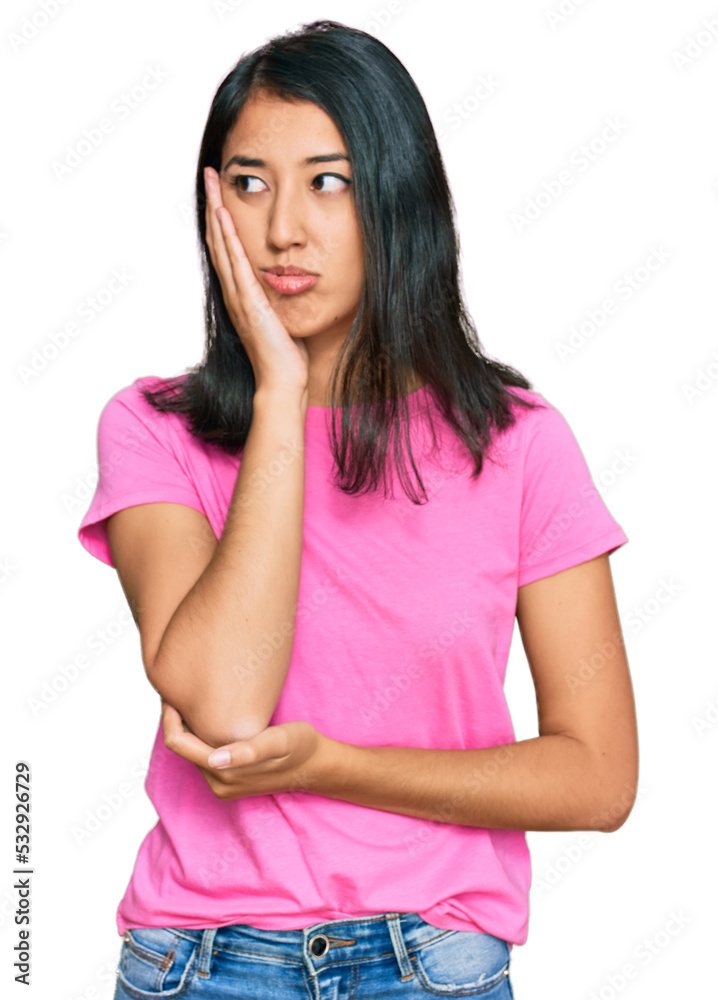 Beautiful asian young woman wearing casual pink t shirt thinking looking tired and bored with depression problems with crossed arms. Beautiful asian young woman wearing casual pink t shirt thinking looking tired and bored with depression problems with crossed arms.