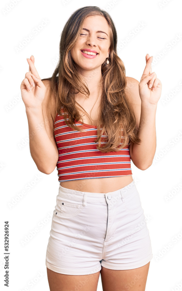 Beautiful caucasian young woman wearing casual clothes gesturing finger crossed smiling with hope and eyes closed. luck and superstitious concept. Beautiful caucasian young woman wearing casual clothes gesturing finger crossed smiling with hope and eyes closed. luck and superstitious concept.