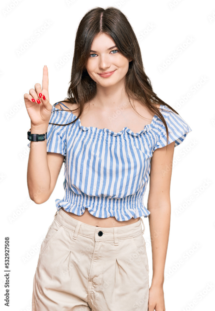 Young beautiful caucasian girl wearing casual clothes showing and pointing up with finger number one while smiling confident and happy. Young beautiful caucasian girl wearing casual clothes showing and pointing up with finger number one while smiling confident and happy.