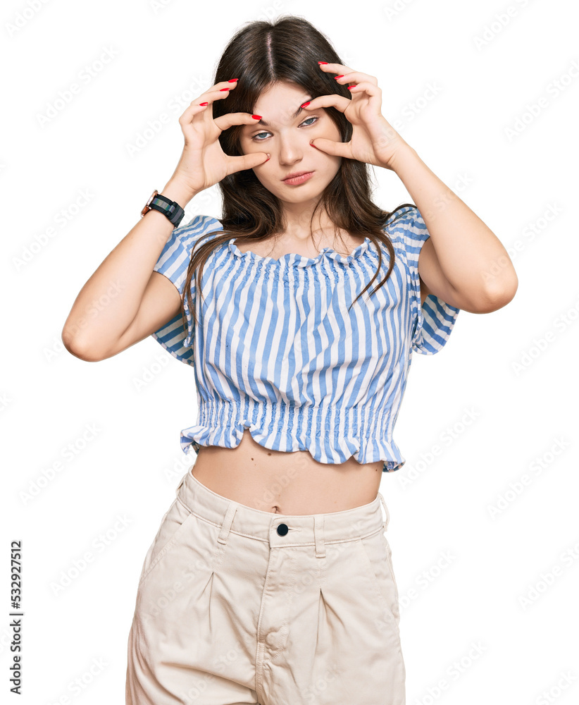 Young beautiful caucasian girl wearing casual clothes trying to open eyes with fingers, sleepy and tired for morning fatigue Young beautiful caucasian girl wearing casual clothes trying to open eyes with fingers, sleepy and tired for morning fatigue