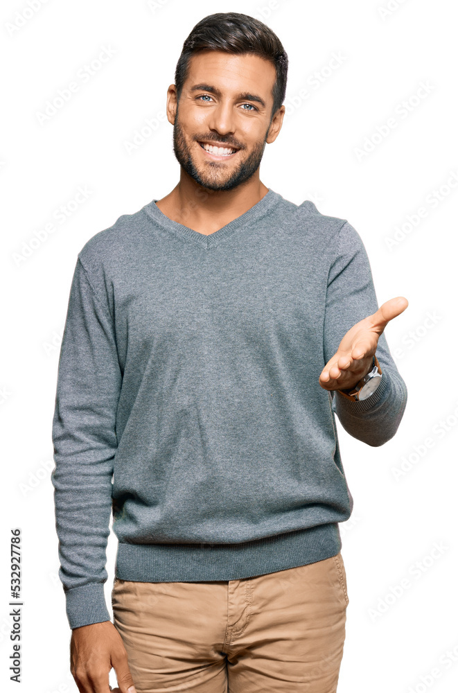 Handsome hispanic man wearing casual clothes smiling friendly offering handshake as greeting and welcoming. successful business. Handsome hispanic man wearing casual clothes smiling friendly offering handshake as greeting and welcoming. successful business.