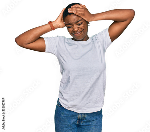 Young african american woman wearing casual white t shirt stretching back, tired and relaxed, sleepy and yawning for early morning