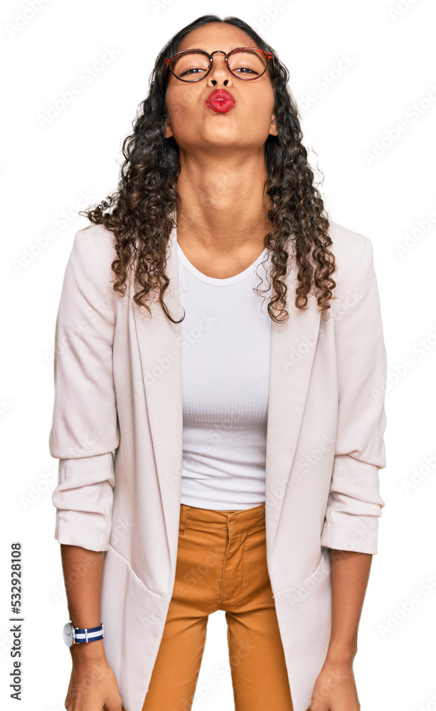 Young african american girl wearing business clothes looking at the camera blowing a kiss on air being lovely and sexy. love expression. Young african american girl wearing business clothes looking at the camera blowing a kiss on air being lovely and sexy. love expression.