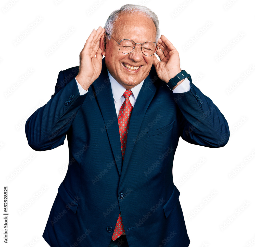 Senior man with grey hair wearing business suit and glasses trying to hear both hands on ear gesture, curious for gossip. hearing problem, deaf Senior man with grey hair wearing business suit and glasses trying to hear both hands on ear gesture, curious for gossip. hearing problem, deaf