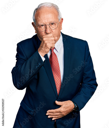 Senior man with grey hair wearing business suit and glasses feeling unwell and coughing as symptom for cold or bronchitis. health care concept.