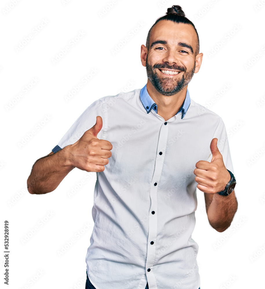 Hispanic man with ponytail wearing casual white shirt success sign doing positive gesture with hand, thumbs up smiling and happy. cheerful expression and winner gesture. Hispanic man with ponytail wearing casual white shirt success sign doing positive gesture with hand, thumbs up smiling and happy. cheerful expression and winner gesture.