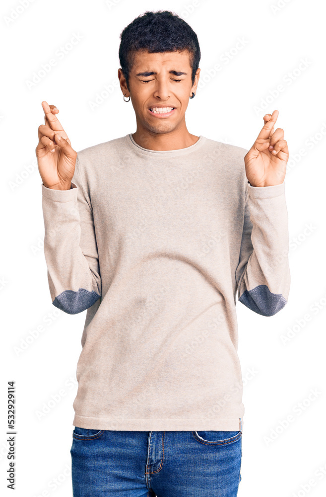 Young african amercian man wearing casual clothes gesturing finger crossed smiling with hope and eyes closed. luck and superstitious concept. Young african amercian man wearing casual clothes gesturing finger crossed smiling with hope and eyes closed. luck and superstitious concept.