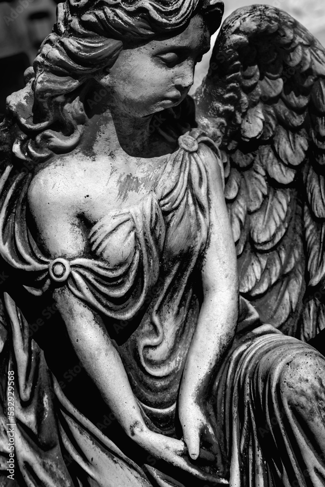 Death concept. Sad beautiful angel as symbol of pain, fear and end of life. Black and white image. Vertical image.
