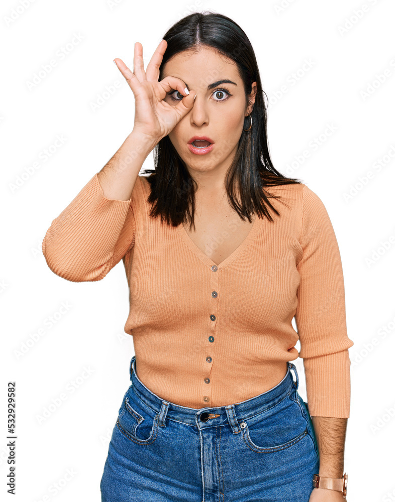 Young hispanic woman wearing casual clothes doing ok gesture shocked with surprised face, eye looking through fingers. unbelieving expression. Young hispanic woman wearing casual clothes doing ok gesture shocked with surprised face, eye looking through fingers. unbelieving expression.