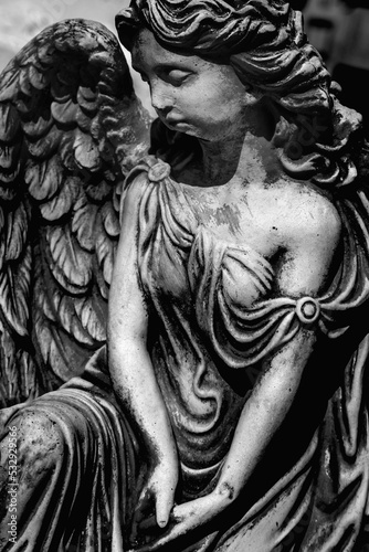 Death concept. Beautiful angel as symbol of pain, fear and end of life. Black and white image. Vertical image.