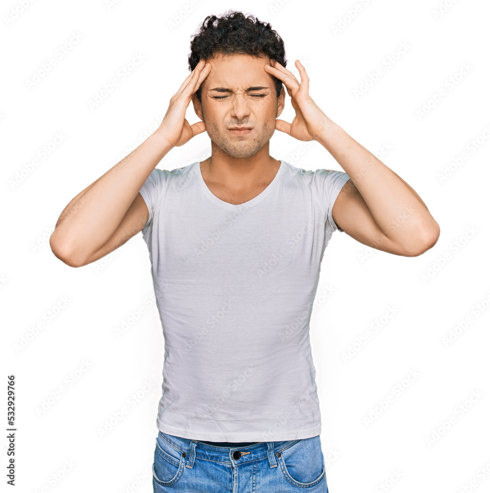Young handsome man wearing casual white t shirt suffering from headache desperate and stressed because pain and migraine. hands on head. Young handsome man wearing casual white t shirt suffering from headache desperate and stressed because pain and migraine. hands on head.