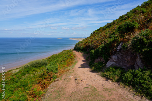 Down a steep path to Rhossili beach on a summer morning