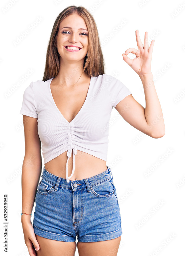 Young beautiful blonde woman wearing casual white tshirt smiling positive doing ok sign with hand and fingers. successful expression. Young beautiful blonde woman wearing casual white tshirt smiling positive doing ok sign with hand and fingers. successful expression.