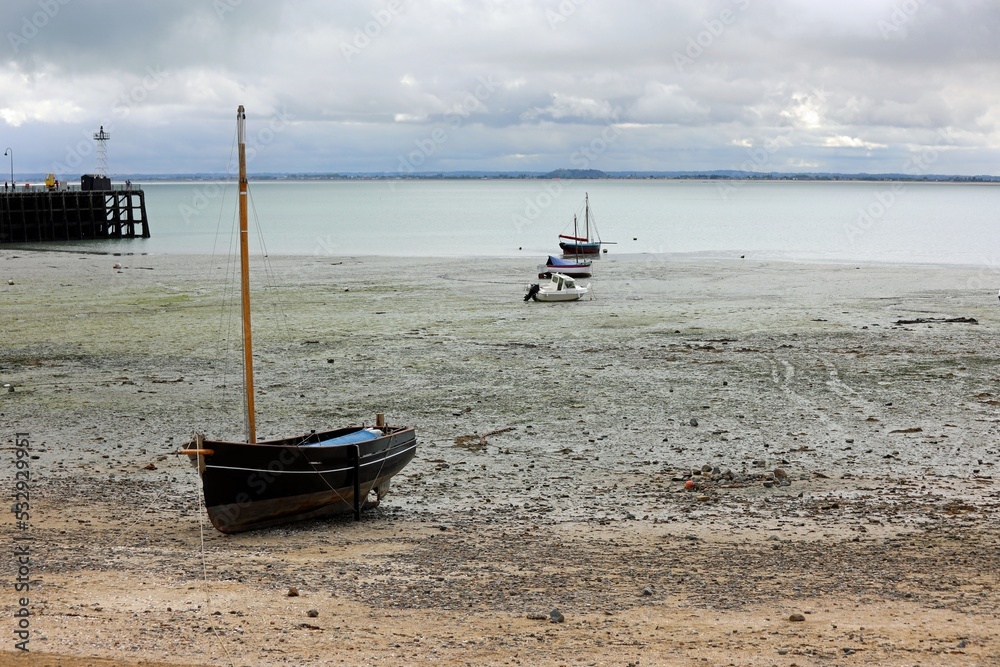 beached boats on the seabed during low tide in the Cancale village in France beached boats on the seabed during low tide in the Cancale village in France