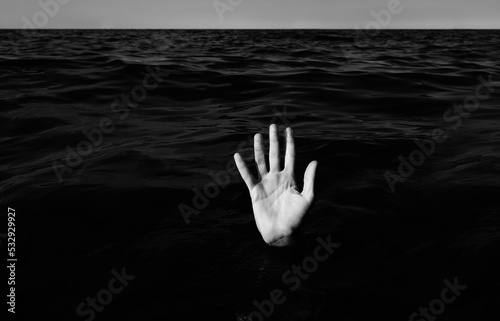 Canvastavla hand on the sea  of a person who is drowning with balck and white effect