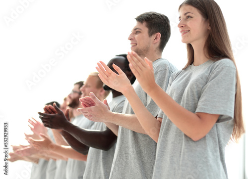 image a group of young people standing in a row applauding.