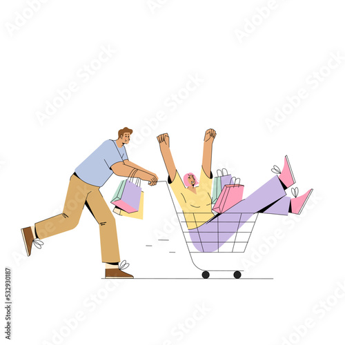 Young man pushing supermarket trolley with shopping and woman sitting in it.