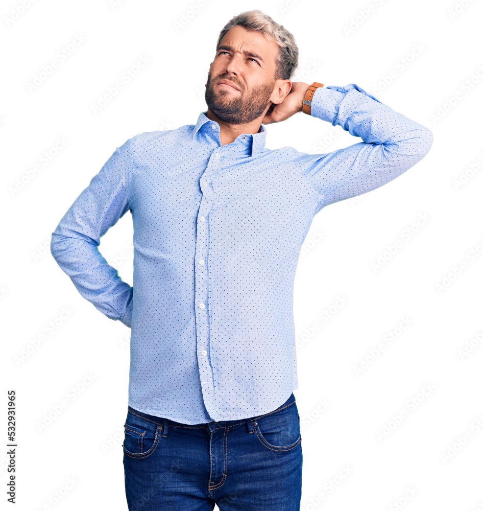 Young handsome blond man wearing elegant shirt suffering of neck ache injury, touching neck with hand, muscular pain Young handsome blond man wearing elegant shirt suffering of neck ache injury, touching neck with hand, muscular pain