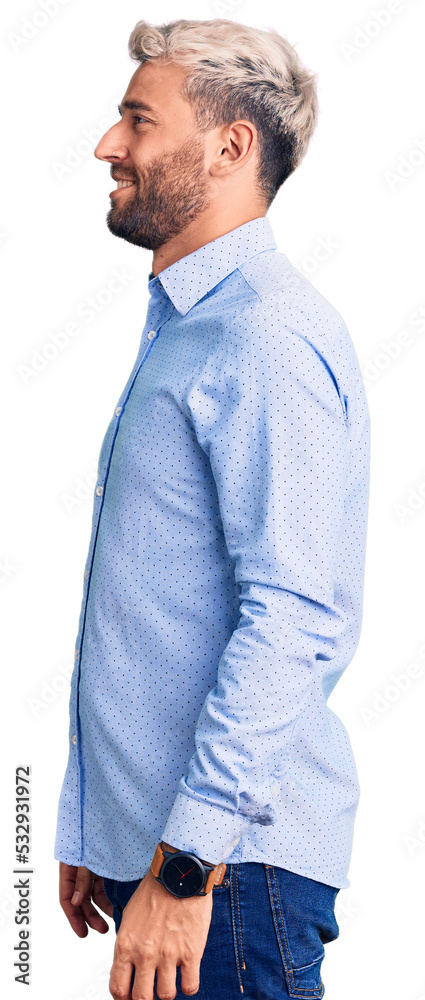 Young handsome blond man wearing elegant shirt looking to side, relax profile pose with natural face and confident smile. Young handsome blond man wearing elegant shirt looking to side, relax profile pose with natural face and confident smile.