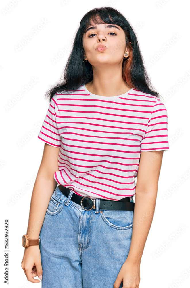 Obraz premium Young hispanic girl wearing casual clothes looking at the camera blowing a kiss on air being lovely and sexy. love expression.