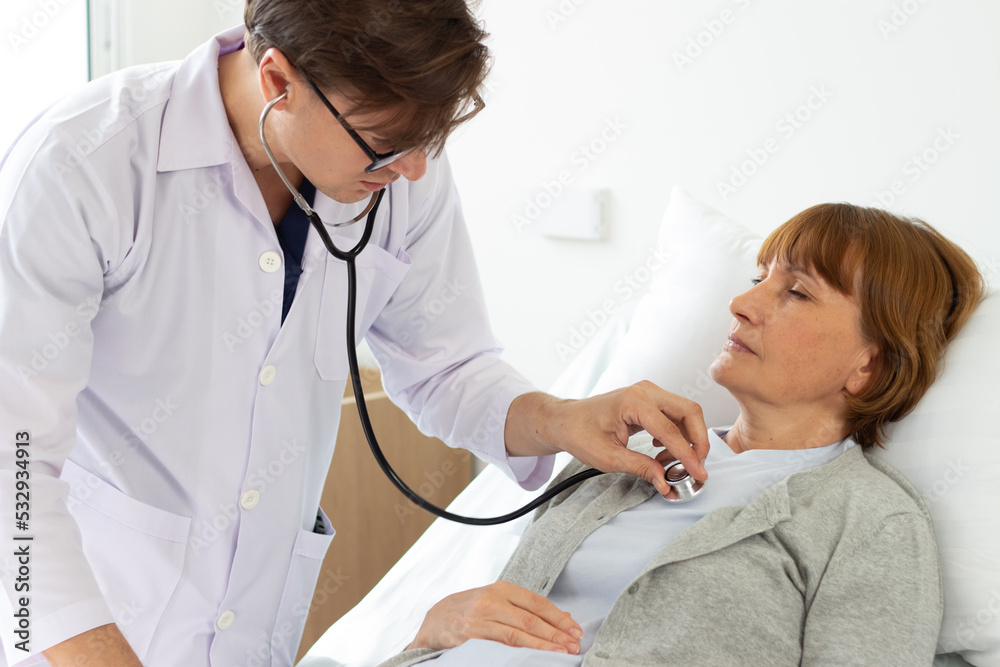 Fototapeta premium the doctor is examining the patient in the hospital. white male doctor examining an elderly female white patient.
