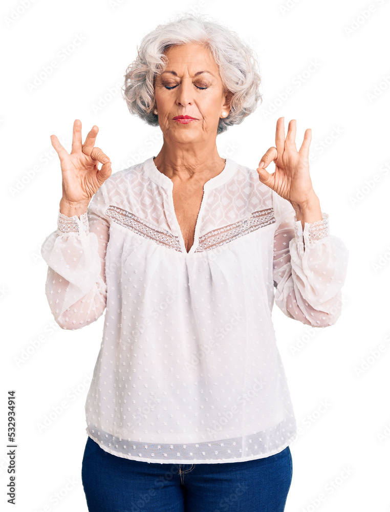 Senior grey-haired woman wearing casual clothes relax and smiling with eyes closed doing meditation gesture with fingers. yoga concept. Senior grey-haired woman wearing casual clothes relax and smiling with eyes closed doing meditation gesture with fingers. yoga concept.