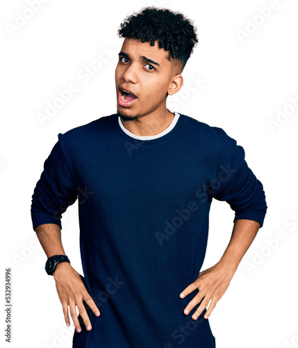 Young african american man wearing casual clothes in shock face, looking skeptical and sarcastic, surprised with open mouth