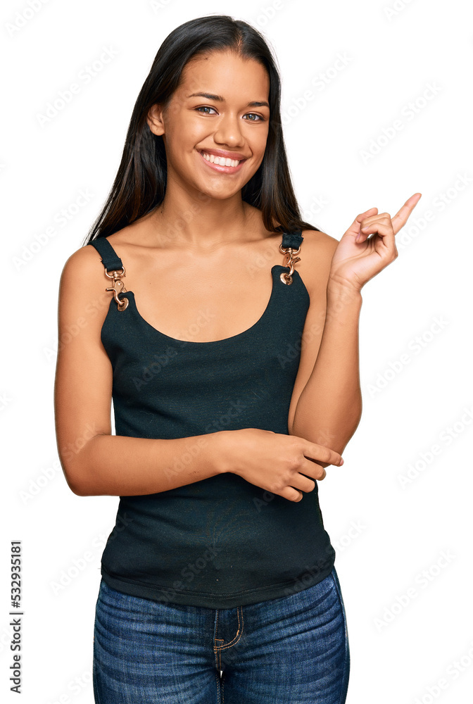 Beautiful hispanic woman wearing casual clothes smiling happy pointing with hand and finger to the side Beautiful hispanic woman wearing casual clothes smiling happy pointing with hand and finger to the side
