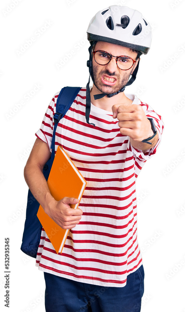 Young hispanic man wearing student backpack and bike helmet holding binder annoyed and frustrated shouting with anger, yelling crazy with anger and hand raised Young hispanic man wearing student backpack and bike helmet holding binder annoyed and frustrated shouting with anger, yelling crazy with anger and hand raised