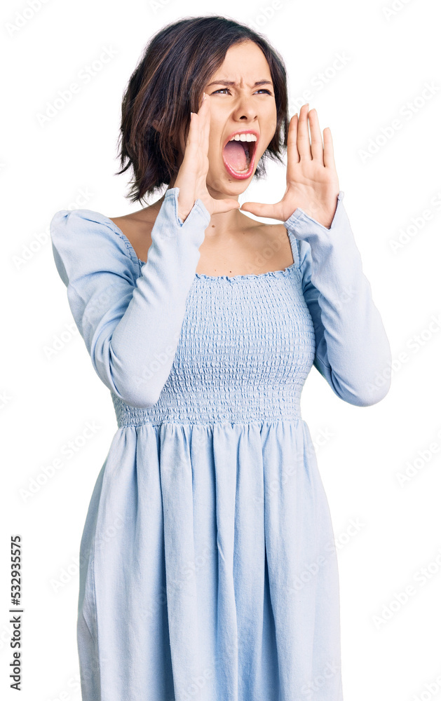 Young beautiful girl wearing casual clothes shouting angry out loud with hands over mouth Young beautiful girl wearing casual clothes shouting angry out loud with hands over mouth