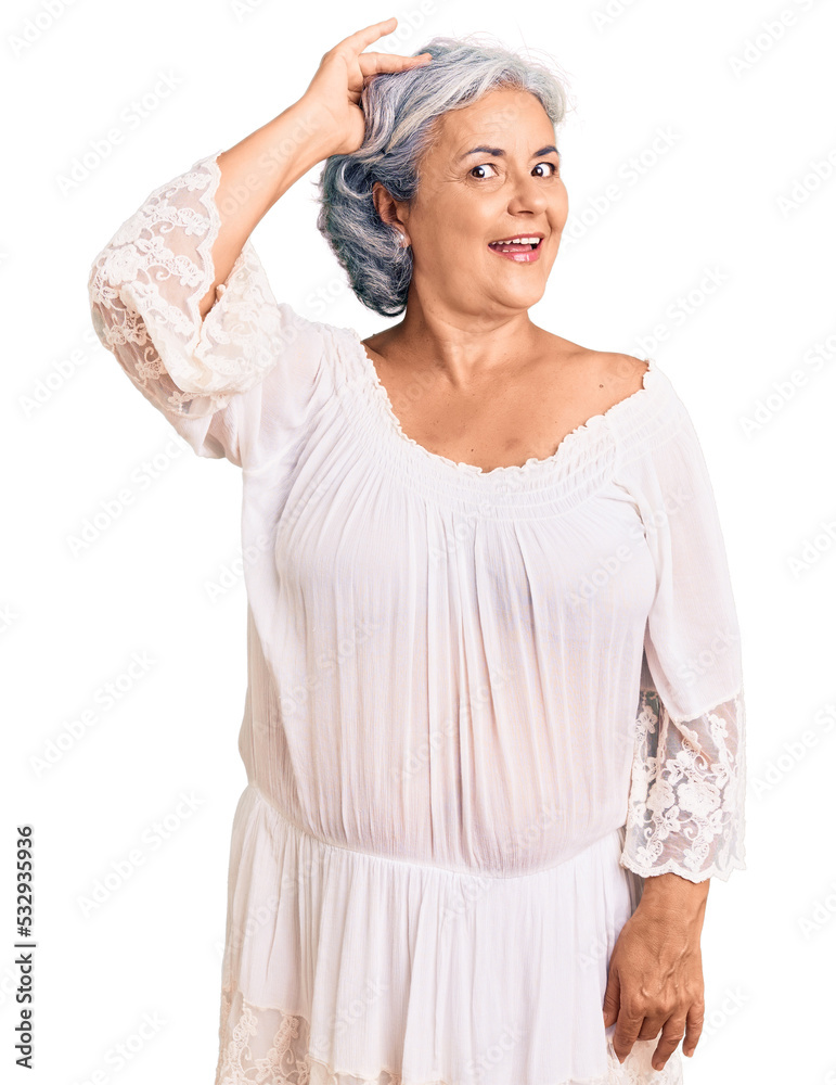 Senior woman with gray hair wearing bohemian style smiling confident touching hair with hand up gesture, posing attractive and fashionable Senior woman with gray hair wearing bohemian style smiling confident touching hair with hand up gesture, posing attractive and fashionable