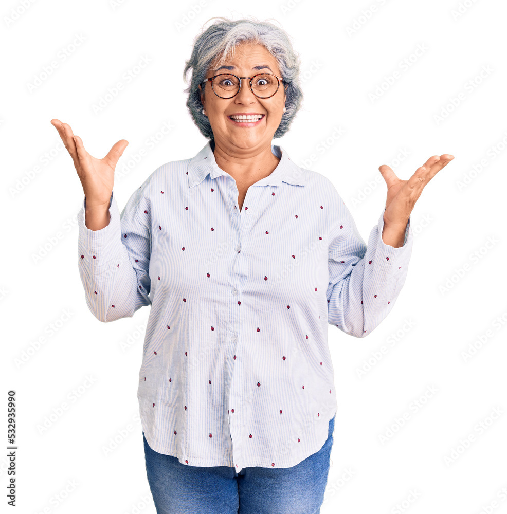 Senior woman with gray hair wearing casual business clothes and glasses celebrating mad and crazy for success with arms raised and closed eyes screaming excited. winner concept Senior woman with gray hair wearing casual business clothes and glasses celebrating mad and crazy for success with arms raised and closed eyes screaming excited. winner concept