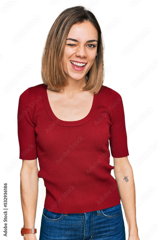 Young blonde girl wearing casual clothes winking looking at the camera with sexy expression, cheerful and happy face. Young blonde girl wearing casual clothes winking looking at the camera with sexy expression, cheerful and happy face.