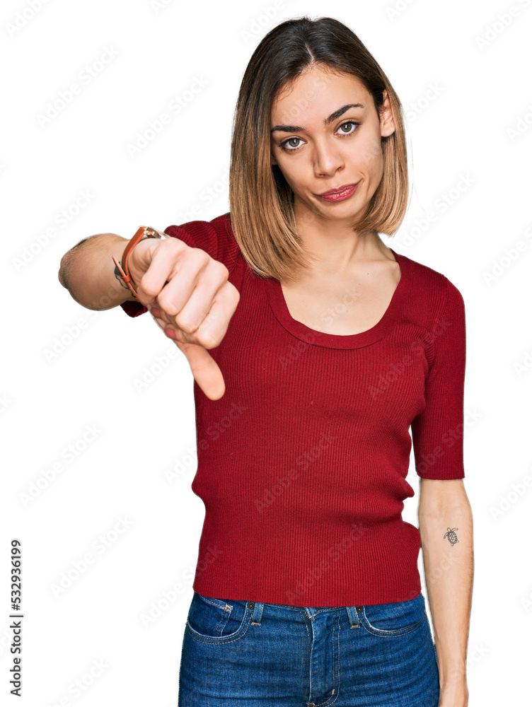 Young blonde girl wearing casual clothes looking unhappy and angry showing rejection and negative with thumbs down gesture. bad expression. Young blonde girl wearing casual clothes looking unhappy and angry showing rejection and negative with thumbs down gesture. bad expression.