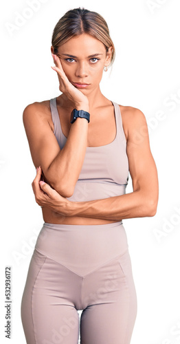 Beautiful caucasian woman wearing sportswear thinking looking tired and bored with depression problems with crossed arms.