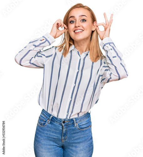 Beautiful caucasian woman wearing casual clothes smiling pulling ears with fingers, funny gesture. audition problem