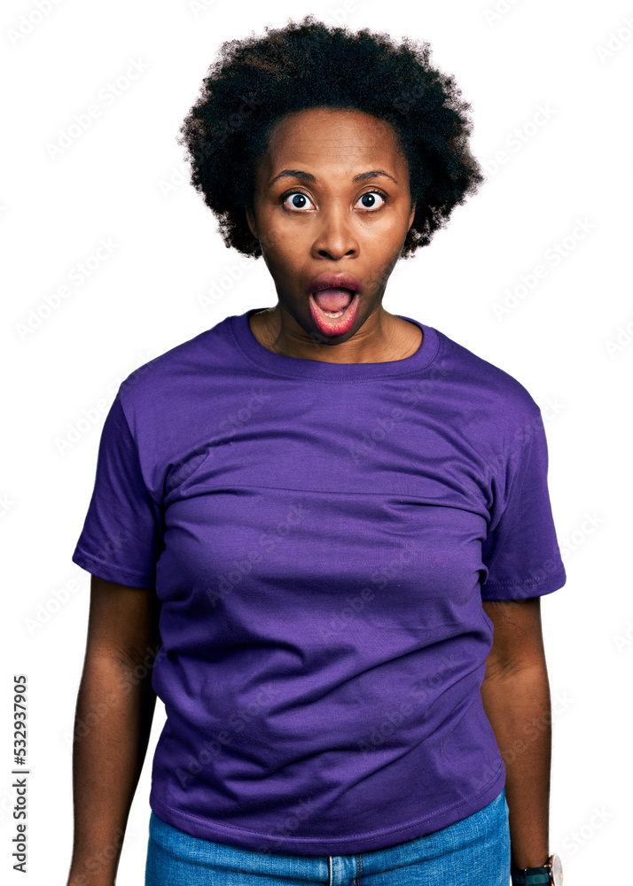 African american woman with afro hair wearing casual purple t shirt afraid and shocked with surprise and amazed expression, fear and excited face. African american woman with afro hair wearing casual purple t shirt afraid and shocked with surprise and amazed expression, fear and excited face.